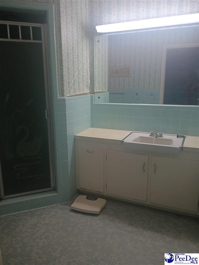1815 Hampton Dr, Florence, SC 29505 - bathroom featuring a wainscoted wall, tile walls, vanity, a shower stall, and wallpapered walls
