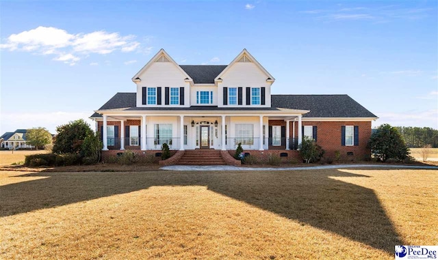 view of front of house with a front yard and covered porch