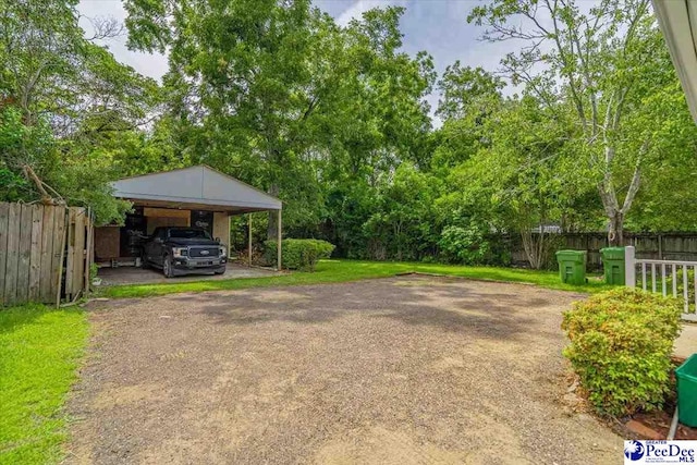904 Madison Ave, Florence, SC 29501 - view of yard with a carport and asphalt driveway