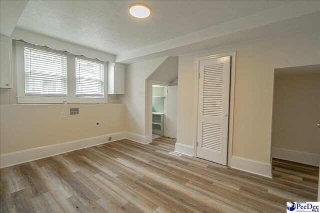 904 Madison Ave, Florence, SC 29501 - empty room featuring a textured ceiling, light wood-style flooring, and baseboards