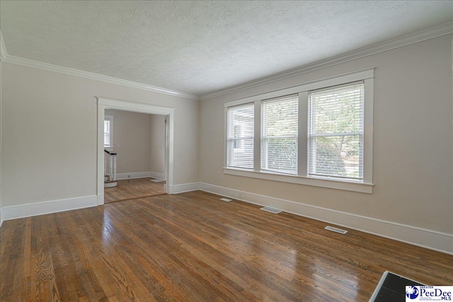 904 Madison Ave, Florence, SC 29501 - spare room with a textured ceiling, plenty of natural light, wood finished floors, ornamental molding, and baseboards