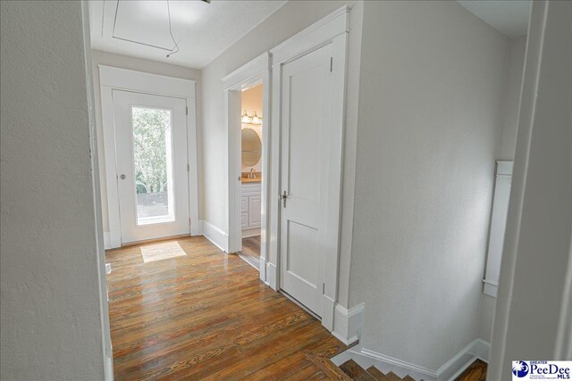 904 Madison Ave, Florence, SC 29501 - hallway with wood finished floors, attic access, baseboards, a textured wall, and a sink