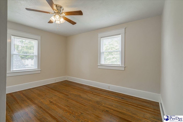 904 Madison Ave, Florence, SC 29501 - empty room featuring dark wood-style floors, baseboards, a ceiling fan, and a textured ceiling