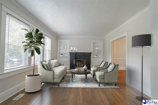 904 Madison Ave, Florence, SC 29501 - living area featuring healthy amount of natural light, baseboards, a textured ceiling, wood finished floors, and built in shelves