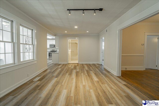 904 Madison Ave, Florence, SC 29501 - unfurnished living room with rail lighting, light wood-style flooring, crown molding, recessed lighting, and baseboards