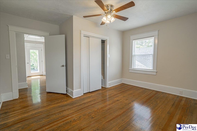 904 Madison Ave, Florence, SC 29501 - unfurnished bedroom with multiple windows, wood finished floors, baseboards, and a closet