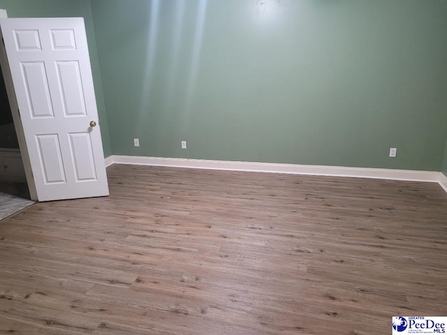 3675 W Pointe Dr, Florence, SC 29501 - empty room with wood finished floors and baseboards