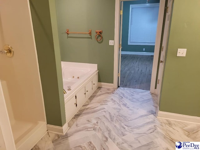 3675 W Pointe Dr, Florence, SC 29501 - bathroom featuring baseboards and a whirlpool tub