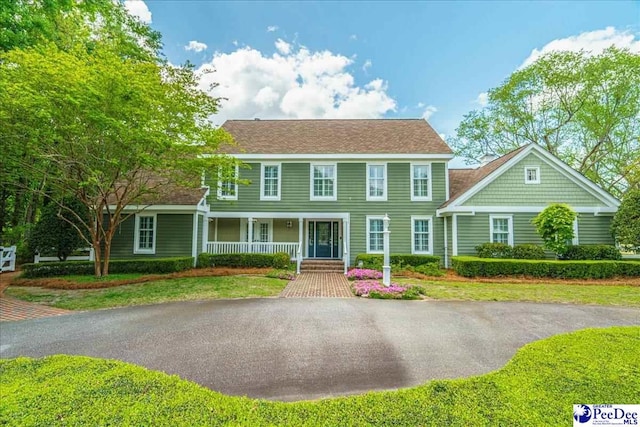 colonial home featuring covered porch