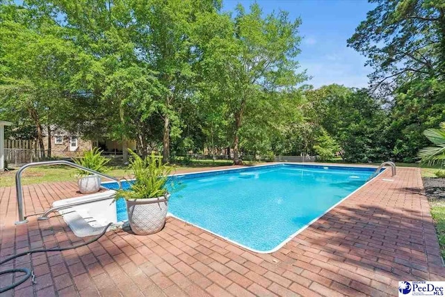 1526 Hunter St, Florence, SC 29505 - swimming pool featuring a patio area and view of wooded area
