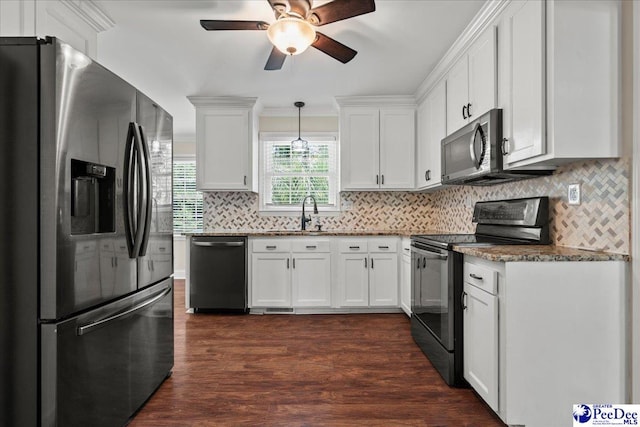 1526 Hunter St, Florence, SC 29505 - kitchen featuring appliances with stainless steel finishes, a ceiling fan, white cabinets, tasteful backsplash, and dark wood-style flooring