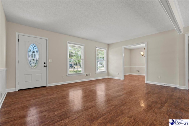 1526 Hunter St, Florence, SC 29505 - foyer entrance with a textured ceiling, wood finished floors, and a chandelier