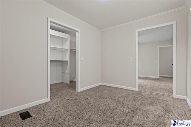 1526 Hunter St, Florence, SC 29505 - unfurnished bedroom featuring carpet floors, crown molding, a spacious closet, and a closet