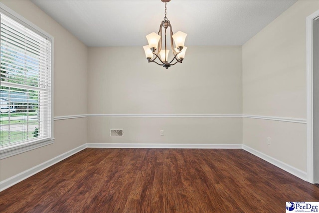 1526 Hunter St, Florence, SC 29505 - empty room featuring a chandelier and dark wood-style flooring