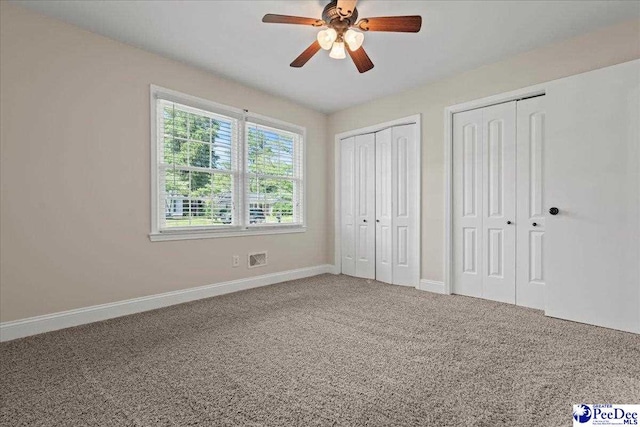 1526 Hunter St, Florence, SC 29505 - unfurnished bedroom featuring carpet flooring, multiple closets, and a ceiling fan