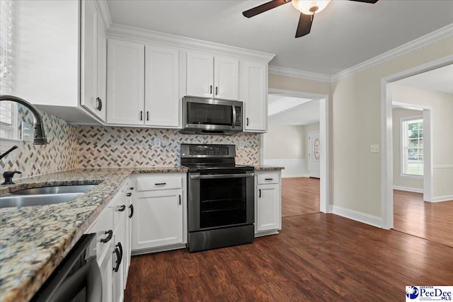 1526 Hunter St, Florence, SC 29505 - kitchen with appliances with stainless steel finishes, ceiling fan, dark wood finished floors, decorative backsplash, and ornamental molding