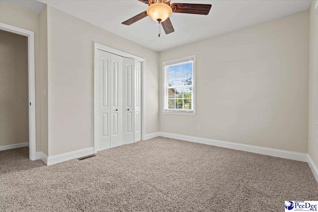 1526 Hunter St, Florence, SC 29505 - unfurnished bedroom with carpet flooring, a closet, and ceiling fan