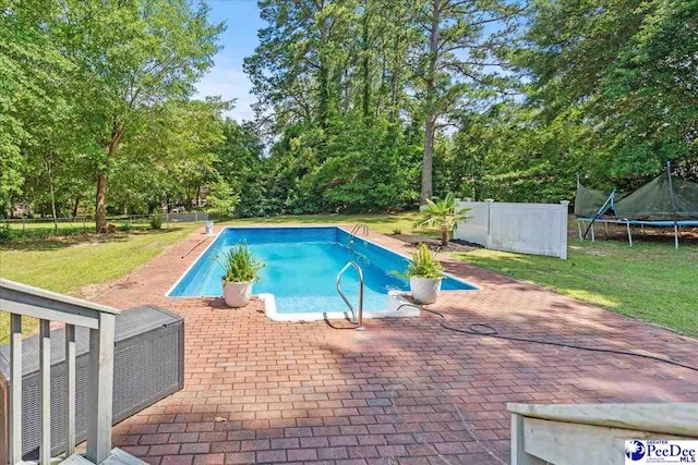 1526 Hunter St, Florence, SC 29505 - view of swimming pool with a trampoline, a patio, a fenced backyard, and view of scattered trees