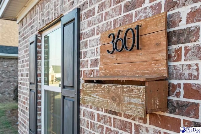 doorway to property with brick siding