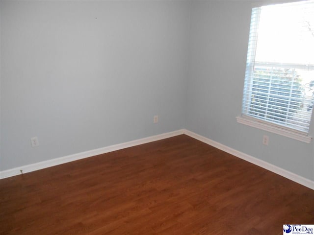 empty room with hardwood / wood-style flooring