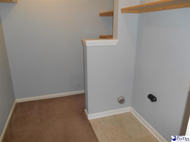 clothes washing area featuring light tile patterned floors