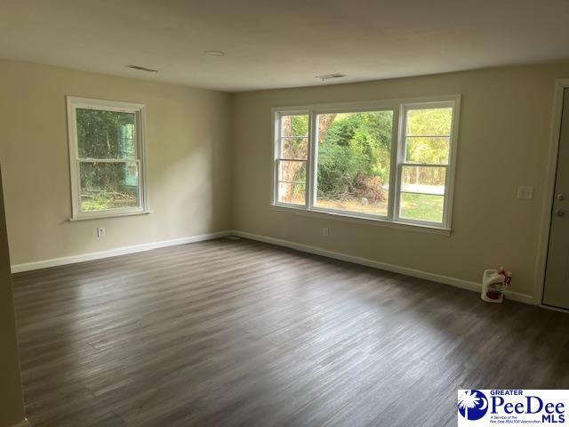 empty room with dark wood-type flooring