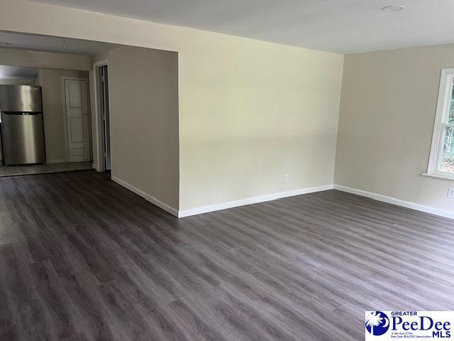 empty room featuring dark wood-type flooring