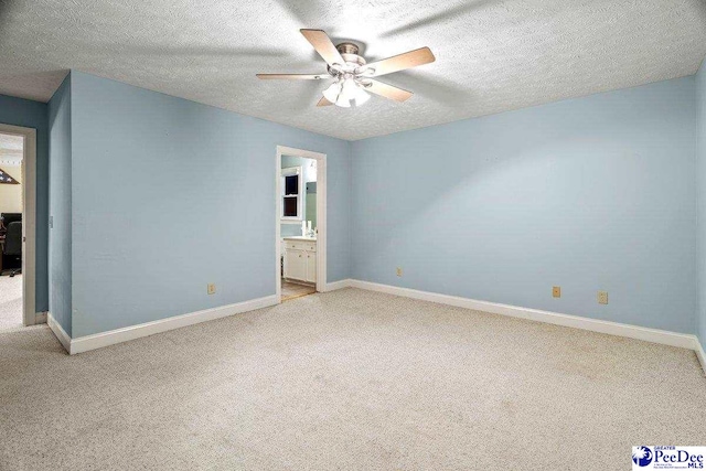 unfurnished bedroom featuring ensuite bathroom, light colored carpet, ceiling fan, and a textured ceiling