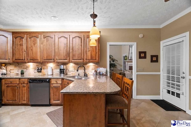 kitchen with stone countertops, dishwasher, sink, hanging light fixtures, and kitchen peninsula