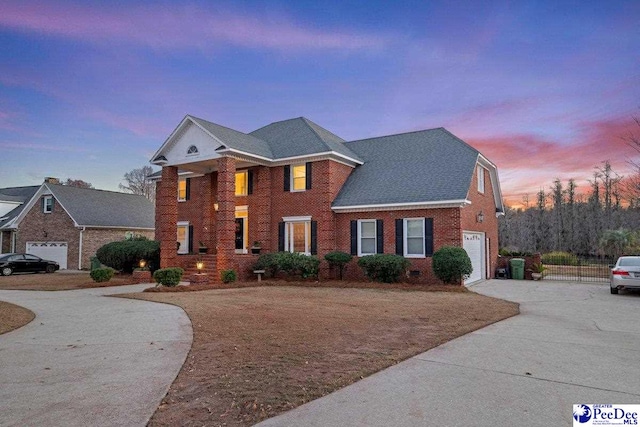 colonial inspired home featuring a garage