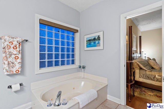 bathroom featuring tile patterned flooring, crown molding, a washtub, and a textured ceiling