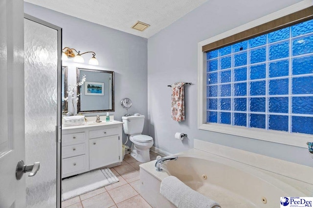 bathroom featuring tile patterned floors, toilet, a textured ceiling, vanity, and a bathtub