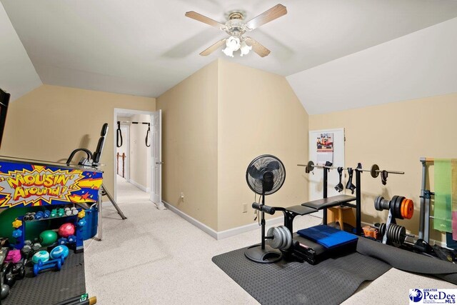 exercise area featuring vaulted ceiling, light colored carpet, and ceiling fan