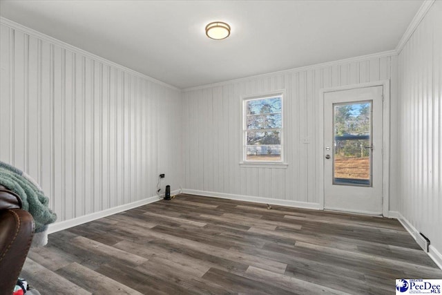 interior space with crown molding, baseboards, and dark wood-style flooring