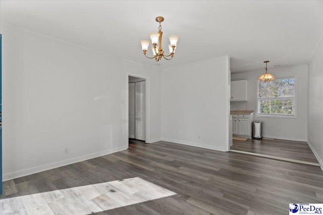 unfurnished living room featuring baseboards, dark wood finished floors, and a notable chandelier