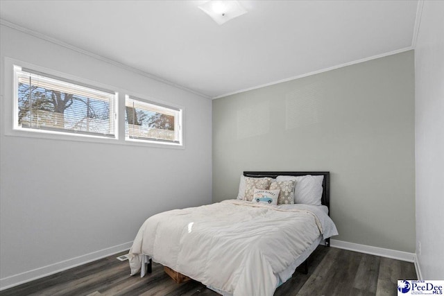 bedroom featuring crown molding, baseboards, and wood finished floors