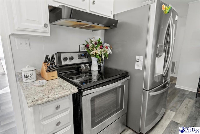 kitchen featuring light stone counters, appliances with stainless steel finishes, white cabinets, wood finished floors, and under cabinet range hood