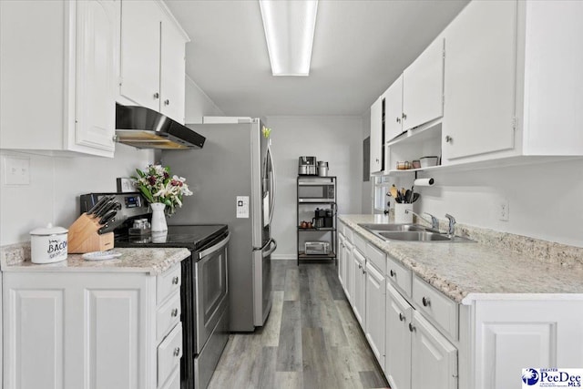 kitchen featuring light countertops, electric range, white cabinetry, a sink, and under cabinet range hood