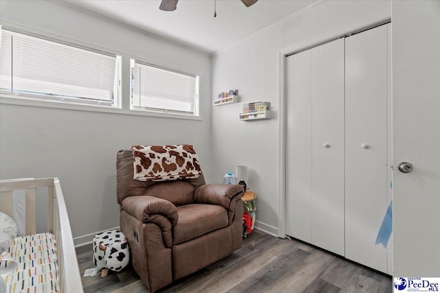 bedroom featuring ornamental molding, a closet, wood finished floors, and baseboards