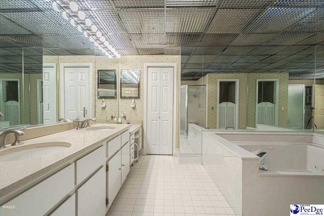 bathroom featuring tile patterned floors, independent shower and bath, and vanity