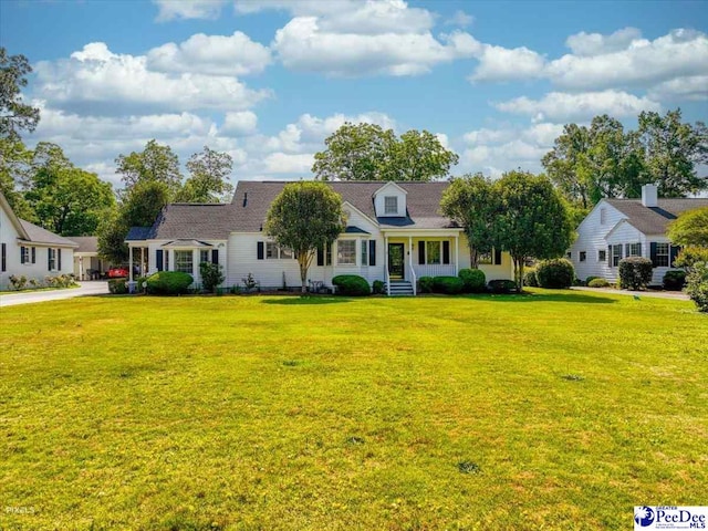 cape cod house with a front lawn