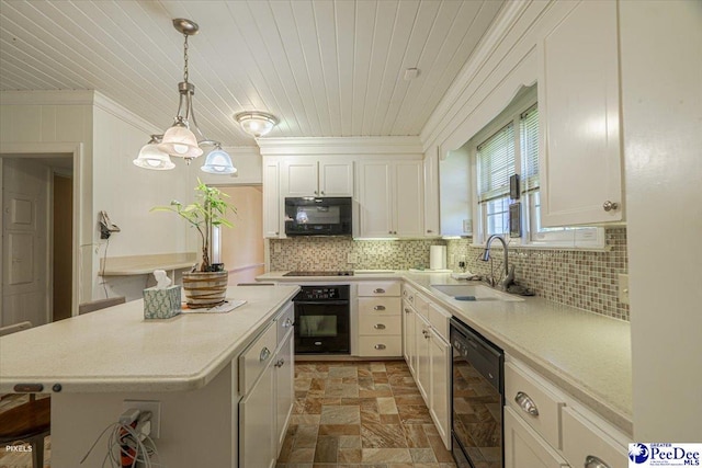 kitchen featuring pendant lighting, white cabinetry, sink, backsplash, and black appliances