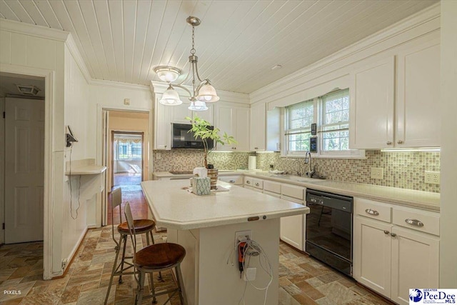 kitchen featuring decorative light fixtures, dishwasher, sink, ornamental molding, and a center island