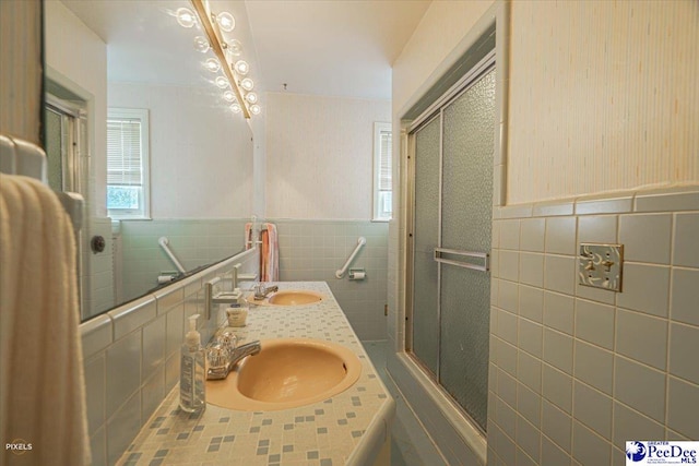 bathroom featuring vanity, an enclosed shower, and tile walls