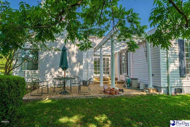 rear view of house with a yard and a patio area