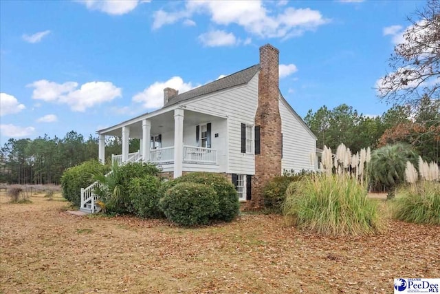 view of side of home featuring a porch