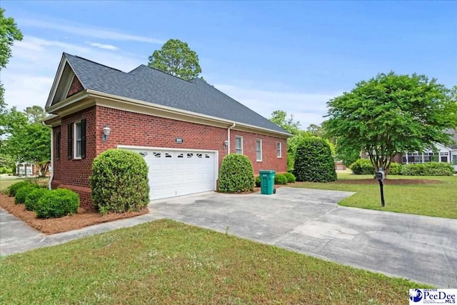 view of side of property featuring concrete driveway, roof with shingles, brick siding, and a lawn