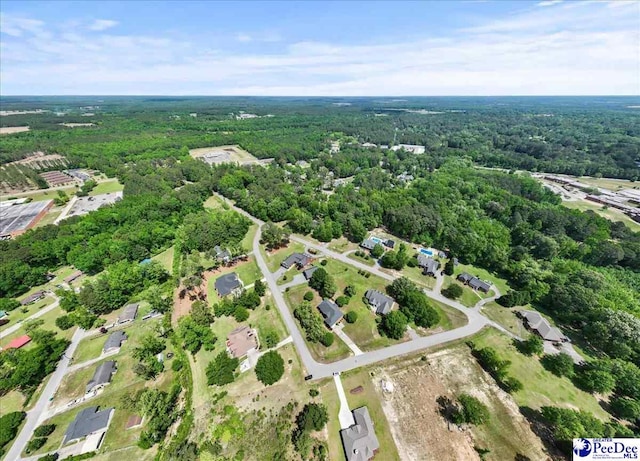 birds eye view of property featuring a view of trees