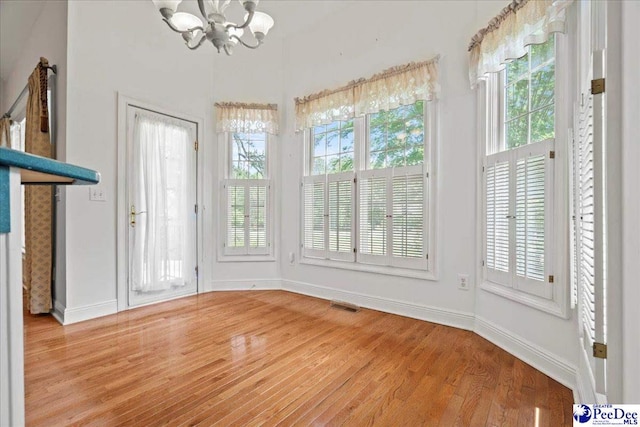 interior space with a chandelier and visible vents