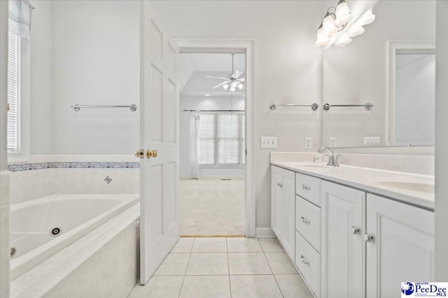 full bath featuring a sink, tile patterned floors, ceiling fan, double vanity, and a whirlpool tub
